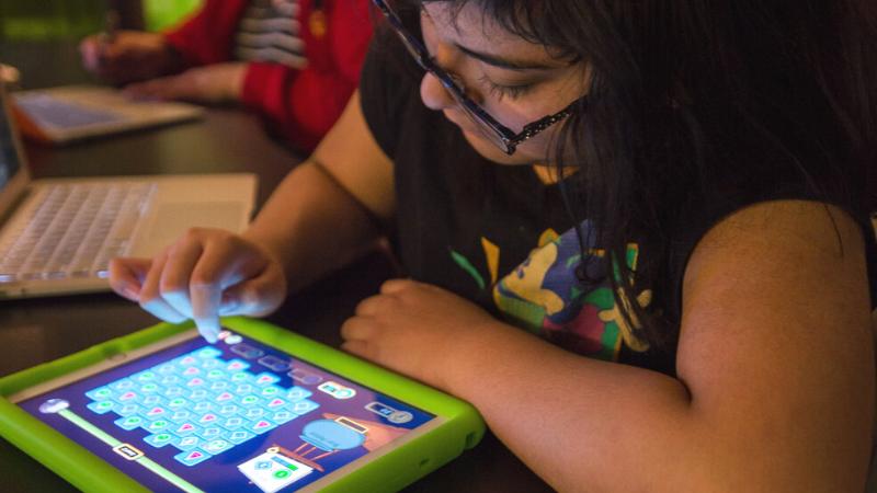 Child playing game on IPad