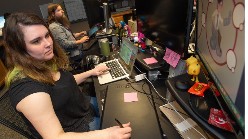 Statia drawing digitally at her desk